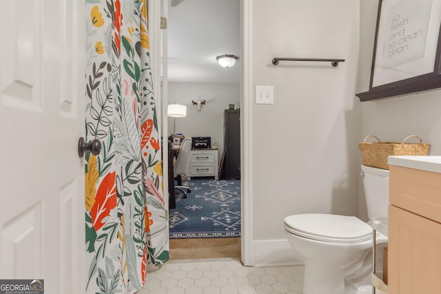 bathroom featuring toilet and vanity