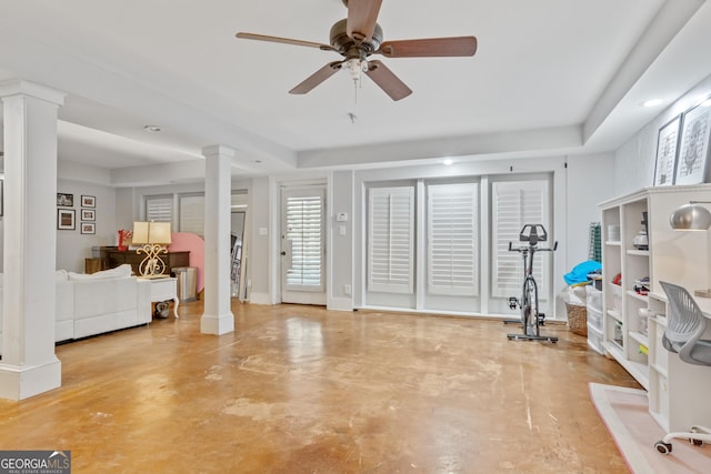 exercise area featuring decorative columns, baseboards, and ceiling fan