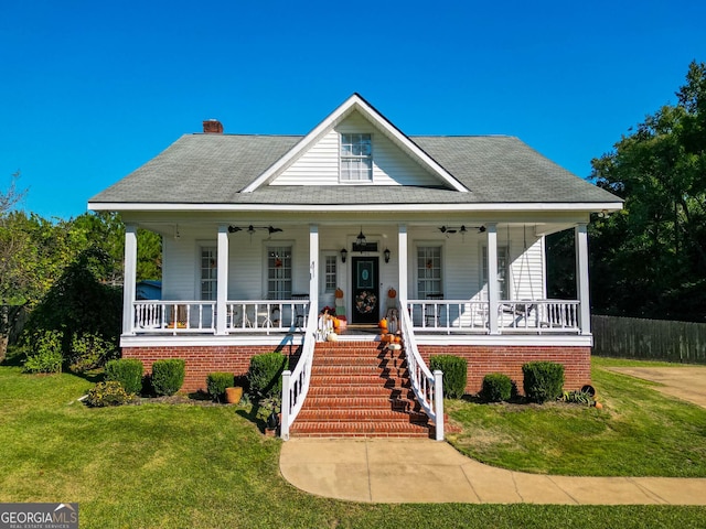 bungalow featuring a front yard, ceiling fan, and a porch