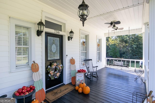 wooden deck featuring ceiling fan and a porch