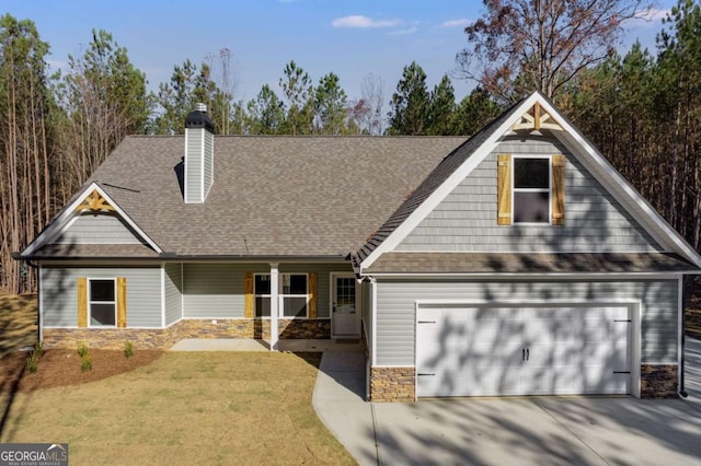 view of front of home with a garage and a front yard