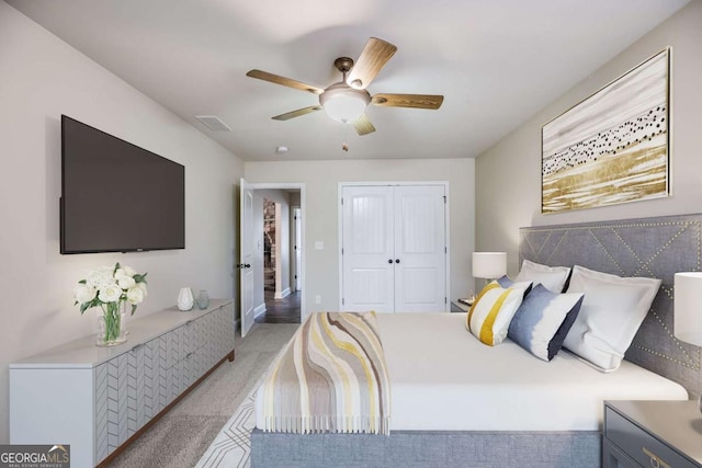 carpeted bedroom with a closet and ceiling fan