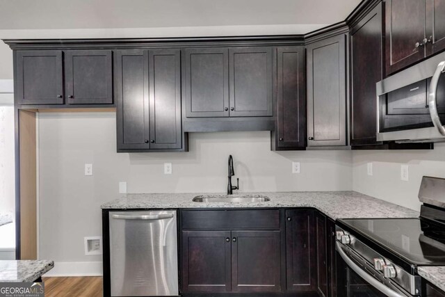 kitchen featuring a kitchen island, pendant lighting, a kitchen breakfast bar, dark brown cabinetry, and light hardwood / wood-style floors