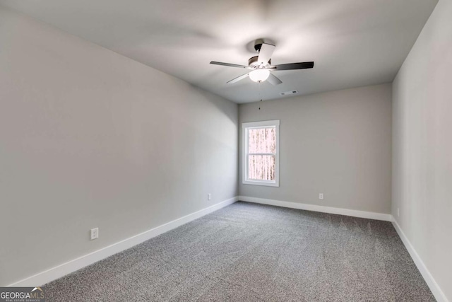 empty room with ceiling fan and carpet flooring