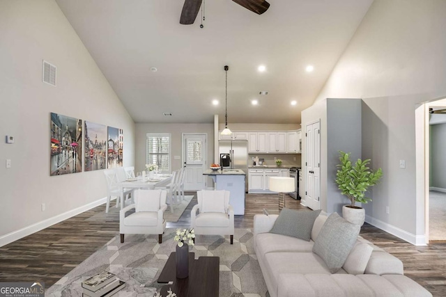 living room with high vaulted ceiling, dark hardwood / wood-style floors, and ceiling fan