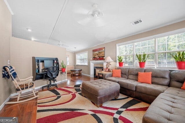 living room featuring crown molding, ceiling fan, and hardwood / wood-style floors