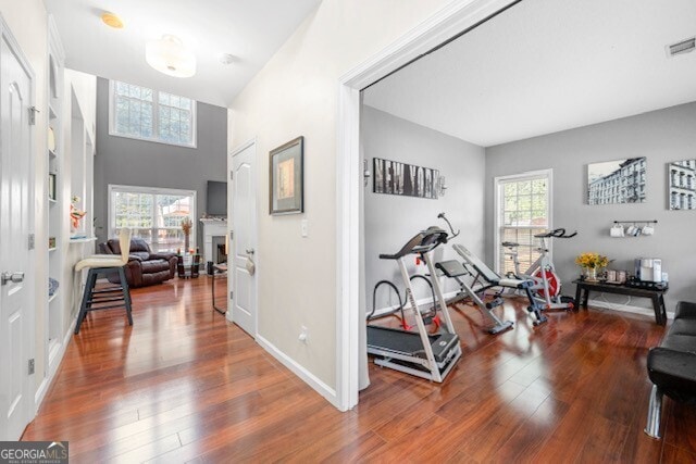 workout area with a wealth of natural light and wood-type flooring