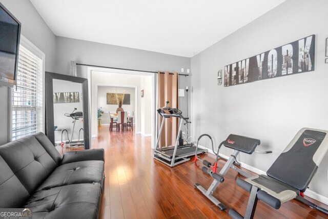 workout area with hardwood / wood-style floors