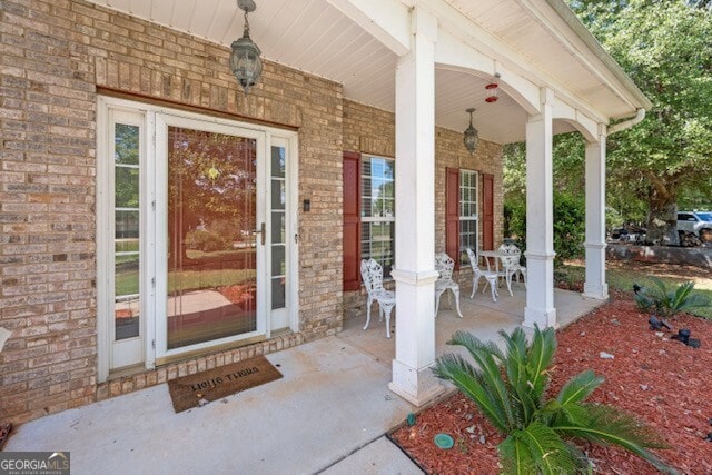 view of exterior entry with a porch