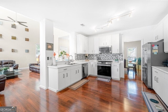 kitchen featuring white cabinetry, sink, decorative backsplash, and appliances with stainless steel finishes