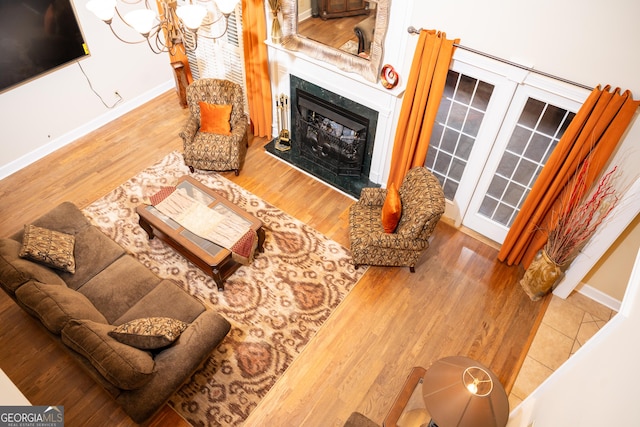 living room featuring a high end fireplace and hardwood / wood-style floors