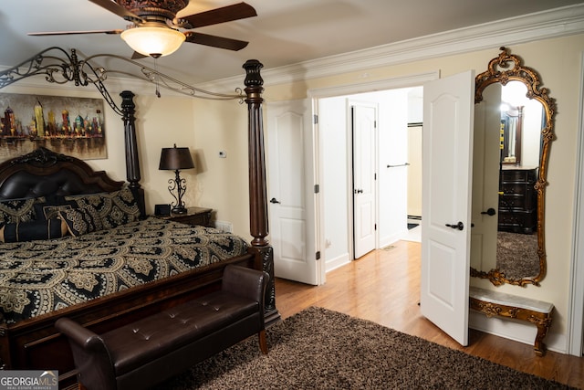 bedroom with ornamental molding, light hardwood / wood-style floors, and ceiling fan