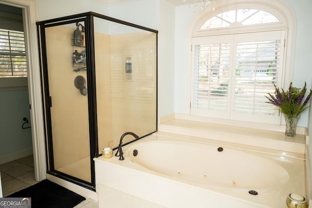 bathroom with separate shower and tub, a healthy amount of sunlight, and tile patterned floors