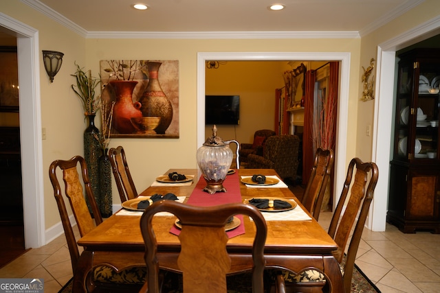 dining room with light tile patterned flooring and crown molding