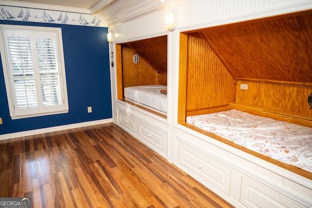 unfurnished bedroom with dark wood-type flooring