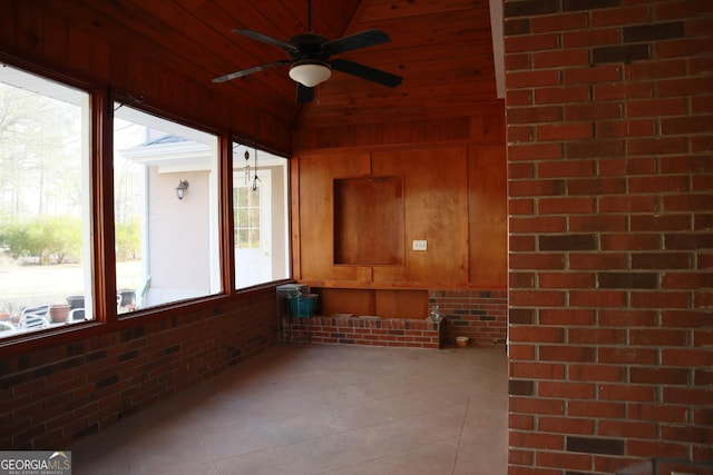 unfurnished sunroom with ceiling fan