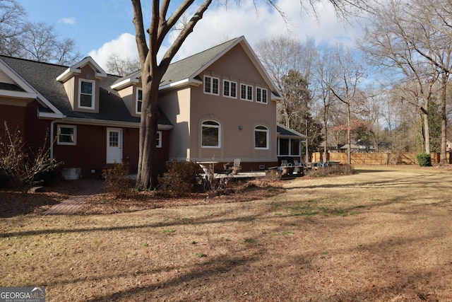 rear view of house featuring a lawn
