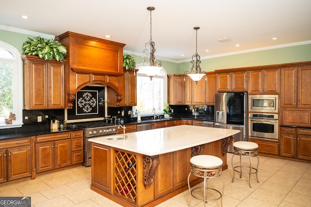 kitchen with tasteful backsplash, decorative light fixtures, a kitchen breakfast bar, stainless steel appliances, and a kitchen island with sink