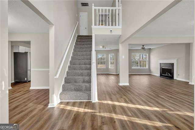 stairway featuring hardwood / wood-style flooring and ceiling fan