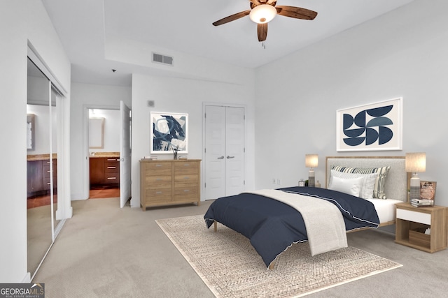 1080 Peachtree St NE Unit 804, Atlanta, GA 30309 - bedroom featuring light carpet, ensuite bathroom, ceiling fan, and visible vents