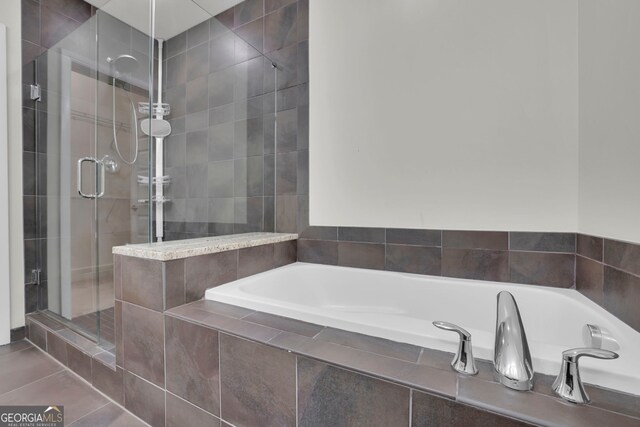 bathroom with tile patterned floors and plus walk in shower