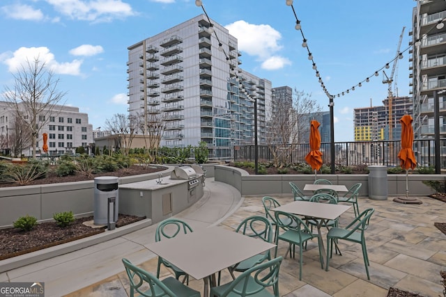 1080 Peachtree St NE Unit 804, Atlanta, GA 30309 - view of patio / terrace featuring fence, outdoor dining area, and area for grilling