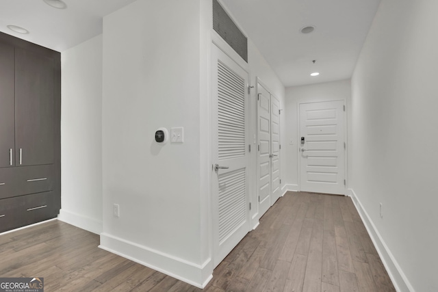 corridor with wood-type flooring