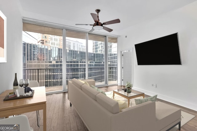 1080 Peachtree St NE Unit 804, Atlanta, GA 30309 - living area with baseboards, a ceiling fan, wood finished floors, and expansive windows