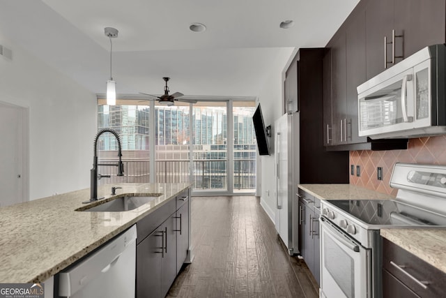 kitchen with white range with electric cooktop, sink, stainless steel dishwasher, dark brown cabinets, and decorative backsplash