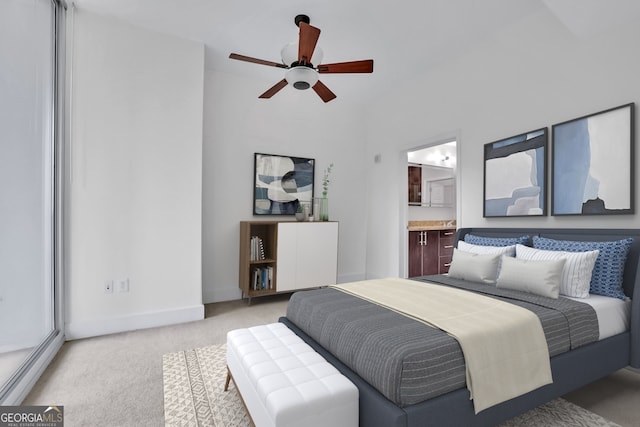 1080 Peachtree St NE Unit 804, Atlanta, GA 30309 - bedroom with ensuite bathroom, light colored carpet, baseboards, and ceiling fan