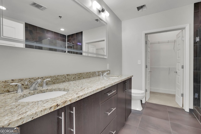 1080 Peachtree St NE Unit 804, Atlanta, GA 30309 - bathroom featuring a spacious closet, double vanity, visible vents, and a sink