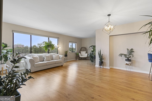 living room featuring a notable chandelier and light hardwood / wood-style flooring