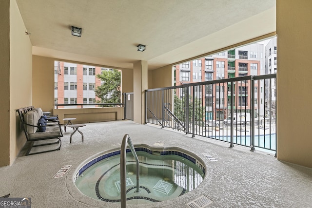 view of swimming pool featuring an indoor hot tub