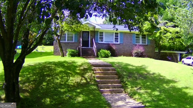 view of front of house with brick siding and a front yard