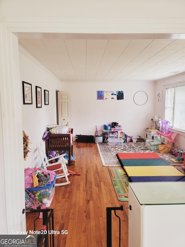 recreation room with hardwood / wood-style floors