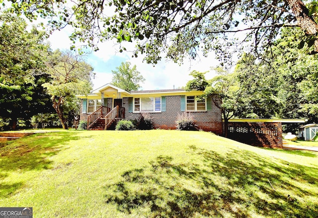 single story home with a front lawn and brick siding