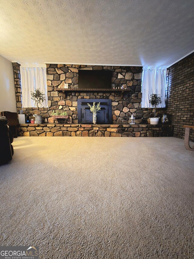 unfurnished living room with a textured ceiling and carpet