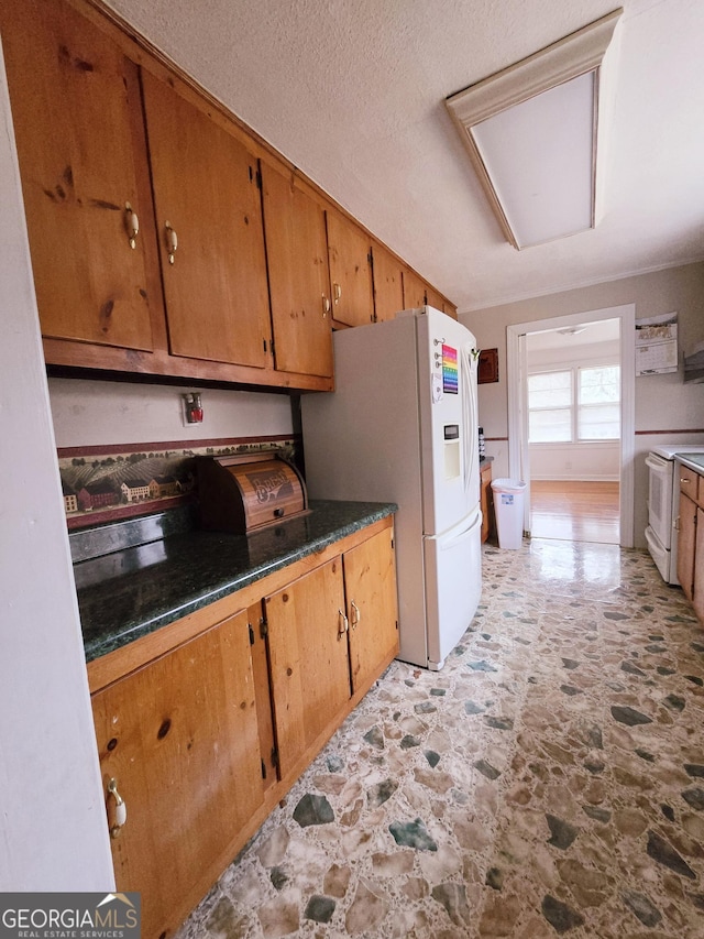 kitchen with white appliances and a textured ceiling