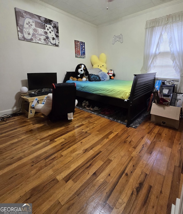 bedroom with ornamental molding and wood-type flooring