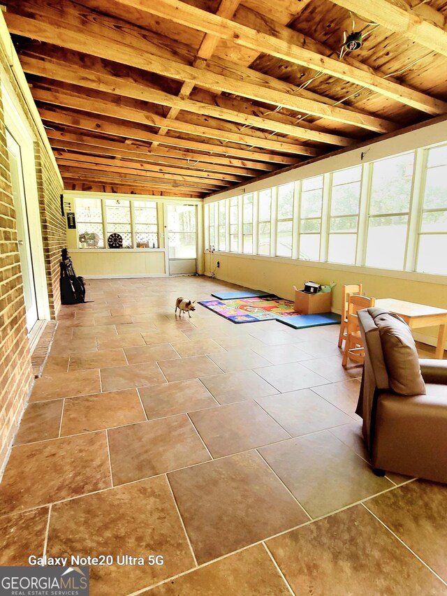 unfurnished sunroom featuring wooden ceiling