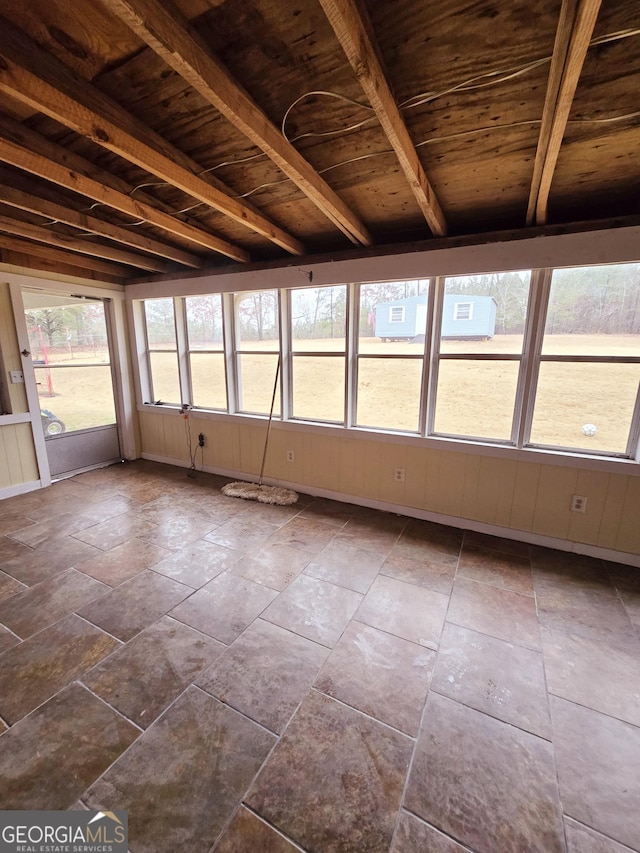 unfurnished sunroom featuring wooden ceiling and beamed ceiling