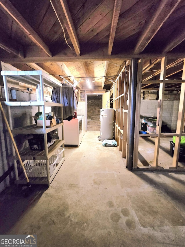 basement with washer and clothes dryer and water heater