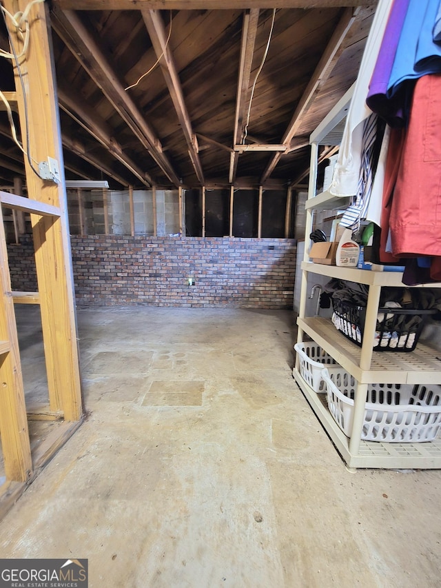 miscellaneous room featuring brick wall