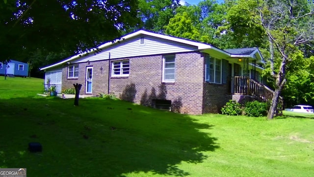 view of home's exterior featuring a yard and brick siding