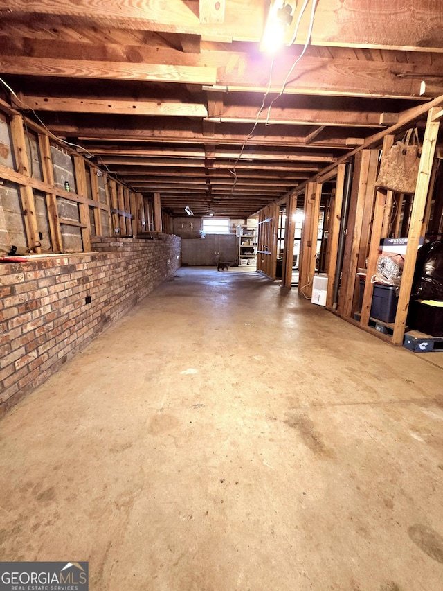 basement featuring brick wall