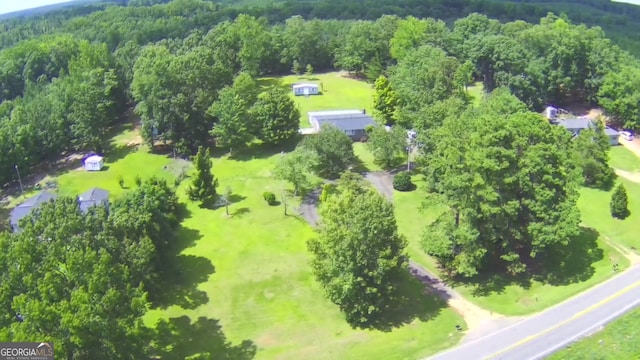 aerial view featuring a wooded view