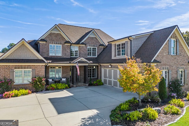 109 Slate Dr, Buford, GA 30518 - craftsman-style home featuring driveway, brick siding, roof with shingles, and an attached garage