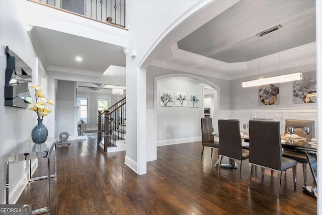 109 Slate Dr, Buford, GA 30518 - dining space with arched walkways, crown molding, wood finished floors, stairs, and baseboards