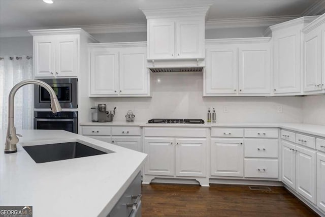 109 Slate Dr, Buford, GA 30518 - kitchen featuring stainless steel appliances, light countertops, white cabinetry, a sink, and ornamental molding