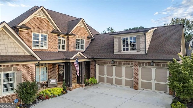 109 Slate Dr, Buford, GA 30518 - view of front of house featuring concrete driveway, brick siding, roof with shingles, and an attached garage